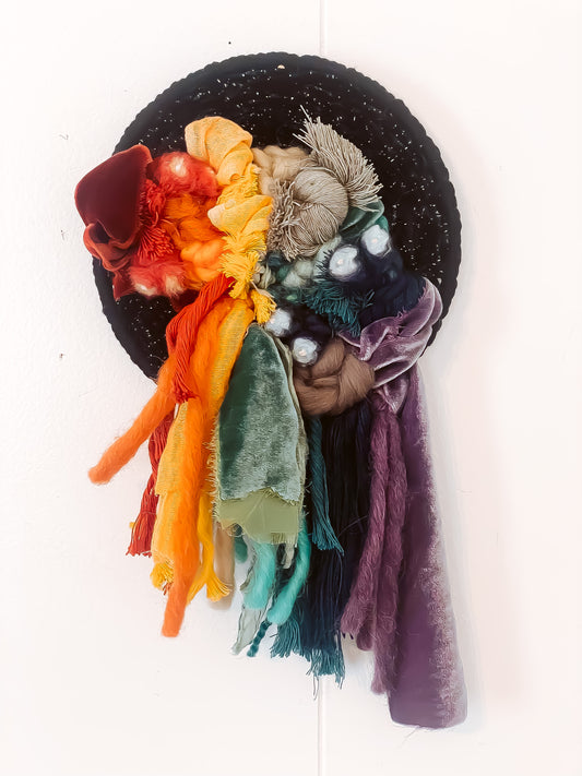 Rainbow wall hanging with various fibers